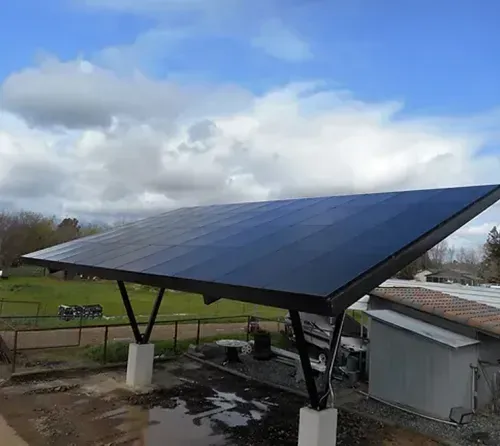 Ground-mounted solar array on an open property, installed by AEC Solar