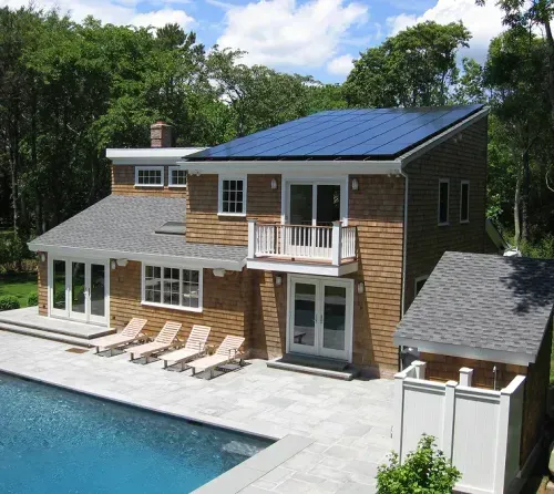 Rooftop solar on a cedar-shingle home with a pool, installed by AEC Solar
